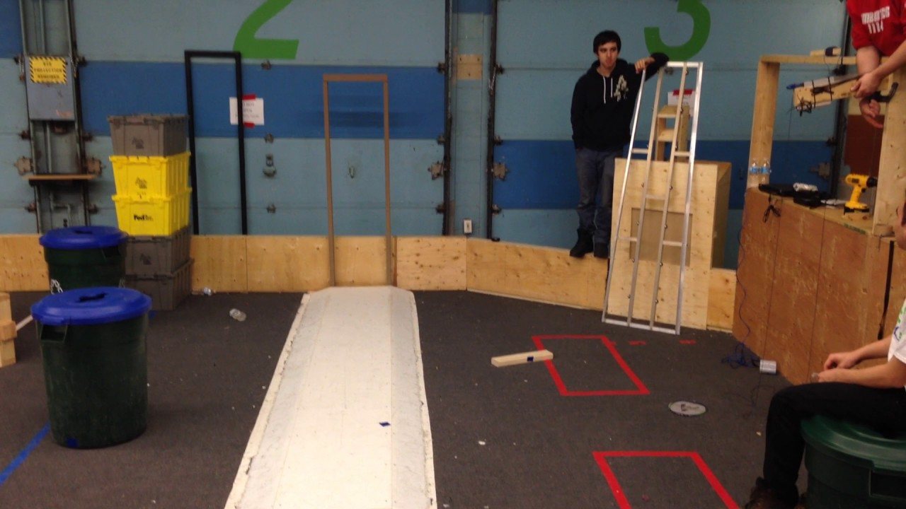 Practice field with the first crossbow prototype held up on the right and bins on the left