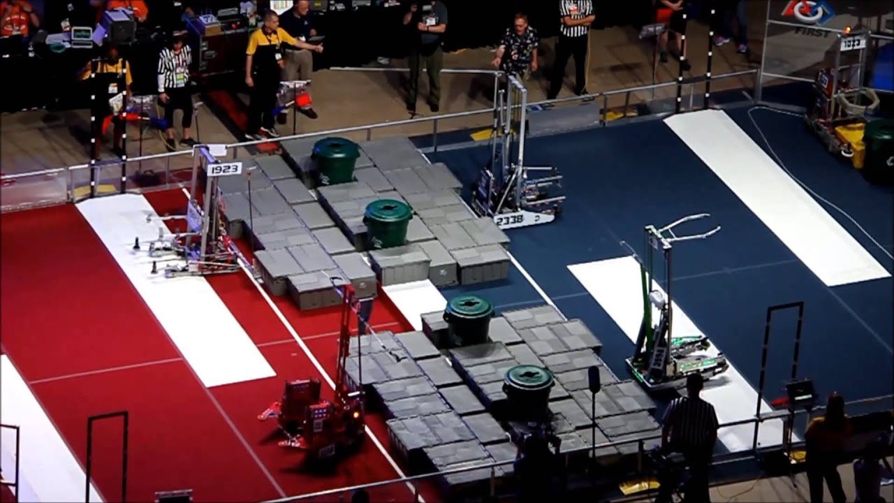 Overhead view of the championship field, with green bins on the central step between the two alliances