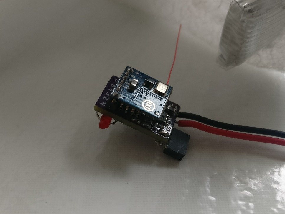 Finished controller with the blue receiver board plugged in on top, a red LED and red and black leads